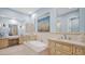 Luxurious bathroom with marble counters, soaking tub, and dual sinks at 8965 E Mountain Spring Rd, Scottsdale, AZ 85255