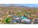 Aerial view of the community pool, tennis courts and clubhouse with mountain views at 8965 E Mountain Spring Rd, Scottsdale, AZ 85255