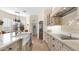 Gourmet kitchen showcasing an island with a farmhouse sink, custom cabinets, and stainless steel appliances at 8965 E Mountain Spring Rd, Scottsdale, AZ 85255