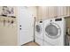 Functional laundry room with modern washer and dryer units and ample storage space at 8965 E Mountain Spring Rd, Scottsdale, AZ 85255