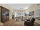 Bright living room featuring wood floors, plantation shutters, and a media center at 8965 E Mountain Spring Rd, Scottsdale, AZ 85255