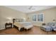 Spacious bedroom with a ceiling fan, plantation shutters, and sitting area at 8965 E Mountain Spring Rd, Scottsdale, AZ 85255