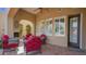Outdoor seating on covered patio with fireplace, ceiling fan, and privacy shutters at 8965 E Mountain Spring Rd, Scottsdale, AZ 85255