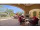 Inviting covered patio with comfortable seating and a cozy fireplace, perfect for outdoor relaxation at 8965 E Mountain Spring Rd, Scottsdale, AZ 85255