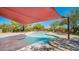 Inviting pool area with shade canopy, surrounded by desert landscape and offering a relaxing outdoor oasis at 8965 E Mountain Spring Rd, Scottsdale, AZ 85255