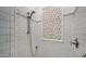 Elegant shower featuring white subway tiles and decorative mosaic tile accent window at 8965 E Mountain Spring Rd, Scottsdale, AZ 85255