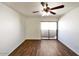 A cozy bedroom featuring a ceiling fan, wood-look floors and sliding doors to a patio at 985 N Granite Reef Rd # 134, Scottsdale, AZ 85257