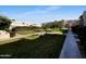 The common area includes grassy areas, walking paths, mature landscaping, and benches at 985 N Granite Reef Rd # 134, Scottsdale, AZ 85257