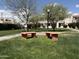 A meticulously kept courtyard with benches, lush lawns, and trees at 985 N Granite Reef Rd # 134, Scottsdale, AZ 85257