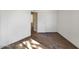 Empty room featuring plank floors and white paint with a door to an adjacent room at 985 N Granite Reef Rd # 134, Scottsdale, AZ 85257