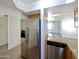 Kitchen with stainless steel appliances and oak cabinets leading to a spacious living area at 985 N Granite Reef Rd # 134, Scottsdale, AZ 85257