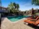 Community pool area featuring lounge chairs and a refreshing swimming pool surrounded by lush greenery at 985 N Granite Reef Rd # 134, Scottsdale, AZ 85257