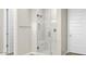 Modern bathroom with glass shower, marble tile, and neutral color palette at 10031 S 23Rd Dr, Phoenix, AZ 85041