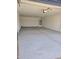 Spacious two-car garage with high ceilings and finished walls at 10031 S 23Rd Dr, Phoenix, AZ 85041