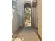 Welcoming courtyard with arched entrance, offering a unique and inviting approach to the home at 10224 E Minnesota Ave, Sun Lakes, AZ 85248
