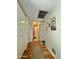 Hallway featuring storage closets and wood-look floors, providing functionality and style at 10224 E Minnesota Ave, Sun Lakes, AZ 85248