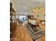 Open-concept living and dining area features hardwood floors and vaulted ceilings at 10224 E Minnesota Ave, Sun Lakes, AZ 85248