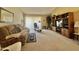 Spacious living room features neutral carpet, cozy sofa, and large windows at 10224 E Minnesota Ave, Sun Lakes, AZ 85248