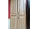 Floor to ceiling light wood pantry cabinet with dark hardware offers ample storage at 10224 E Minnesota Ave, Sun Lakes, AZ 85248