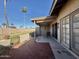 Charming covered patio area with a fan, brick floor and stucco privacy fence at 10224 E Minnesota Ave, Sun Lakes, AZ 85248