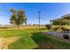 Backyard patio features relaxing seating area with views of lush, green lawn and neighborhood golf course at 10750 W Abbott Ave, Sun City, AZ 85351