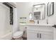 Modern bathroom featuring a sleek vanity, elegant fixtures, and a shower with a stylish black shower system at 10750 W Abbott Ave, Sun City, AZ 85351