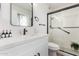 Bright bathroom featuring a modern vanity with white countertop and a sleek glass-enclosed shower at 10750 W Abbott Ave, Sun City, AZ 85351