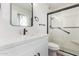 Bright bathroom featuring a modern vanity with white countertop and a sleek glass-enclosed shower at 10750 W Abbott Ave, Sun City, AZ 85351