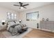 Stylishly decorated bedroom features a modern ceiling fan and an eye-catching accent cabinet at 10750 W Abbott Ave, Sun City, AZ 85351