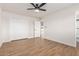 Bright bedroom with wood-look floors and a double door closet at 10750 W Abbott Ave, Sun City, AZ 85351