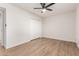 Spacious bedroom with natural light, ceiling fan, and freshly installed wood-look flooring at 10750 W Abbott Ave, Sun City, AZ 85351