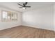 Bright bedroom features wood-look floors and a ceiling fan at 10750 W Abbott Ave, Sun City, AZ 85351