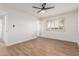 Bright bedroom features wood-look floors and a ceiling fan at 10750 W Abbott Ave, Sun City, AZ 85351