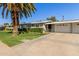 A single story home featuring a well maintained front yard and long driveway at 10750 W Abbott Ave, Sun City, AZ 85351