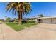 Attractive home showcasing manicured lawn, mature palm trees, and a tidy front exterior at 10750 W Abbott Ave, Sun City, AZ 85351