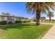 Charming single-story home with well-manicured front lawn, mature palm trees, and inviting curb appeal at 10750 W Abbott Ave, Sun City, AZ 85351