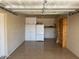 Spacious garage with ample storage, including white cabinets, shelving, and epoxy floors at 10750 W Abbott Ave, Sun City, AZ 85351