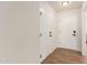Bright hallway with modern wood-look flooring and white doors at 10750 W Abbott Ave, Sun City, AZ 85351