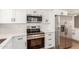 Modern kitchen with stainless steel oven and microwave and white cabinets at 10750 W Abbott Ave, Sun City, AZ 85351