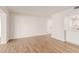 Bright living room features wood-look floors and white walls at 10750 W Abbott Ave, Sun City, AZ 85351