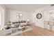 Bright living room with modern decor, stylish furnishings, and wood-look floors at 10750 W Abbott Ave, Sun City, AZ 85351