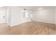 Bright living room features wood-look floors and white walls at 10750 W Abbott Ave, Sun City, AZ 85351