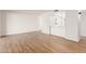 Bright living room features wood-look floors and white walls at 10750 W Abbott Ave, Sun City, AZ 85351