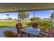 Covered patio with outdoor seating overlooking a well-maintained lawn at 10750 W Abbott Ave, Sun City, AZ 85351