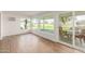 Bright sunroom featuring vinyl floors, large windows, and access to the patio at 10750 W Abbott Ave, Sun City, AZ 85351