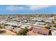 Wide aerial shot of a residential neighborhood featuring neat landscaping, paved streets, and mountain views in the background at 11001 N Madison Dr, Sun City, AZ 85351