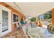 Covered patio with tile flooring, outdoor dining furniture, and views of the garden at 11001 N Madison Dr, Sun City, AZ 85351