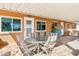 Covered patio with tile flooring, outdoor dining furniture, and views of the garden at 11001 N Madison Dr, Sun City, AZ 85351