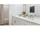 Bright bathroom featuring double sinks, quartz counters, stylish fixtures, and tub/shower at 1123 E Mcneil St, Phoenix, AZ 85042