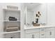 Bright bathroom featuring double sinks, white cabinets, stylish fixtures, and ample storage at 1123 E Mcneil St, Phoenix, AZ 85042